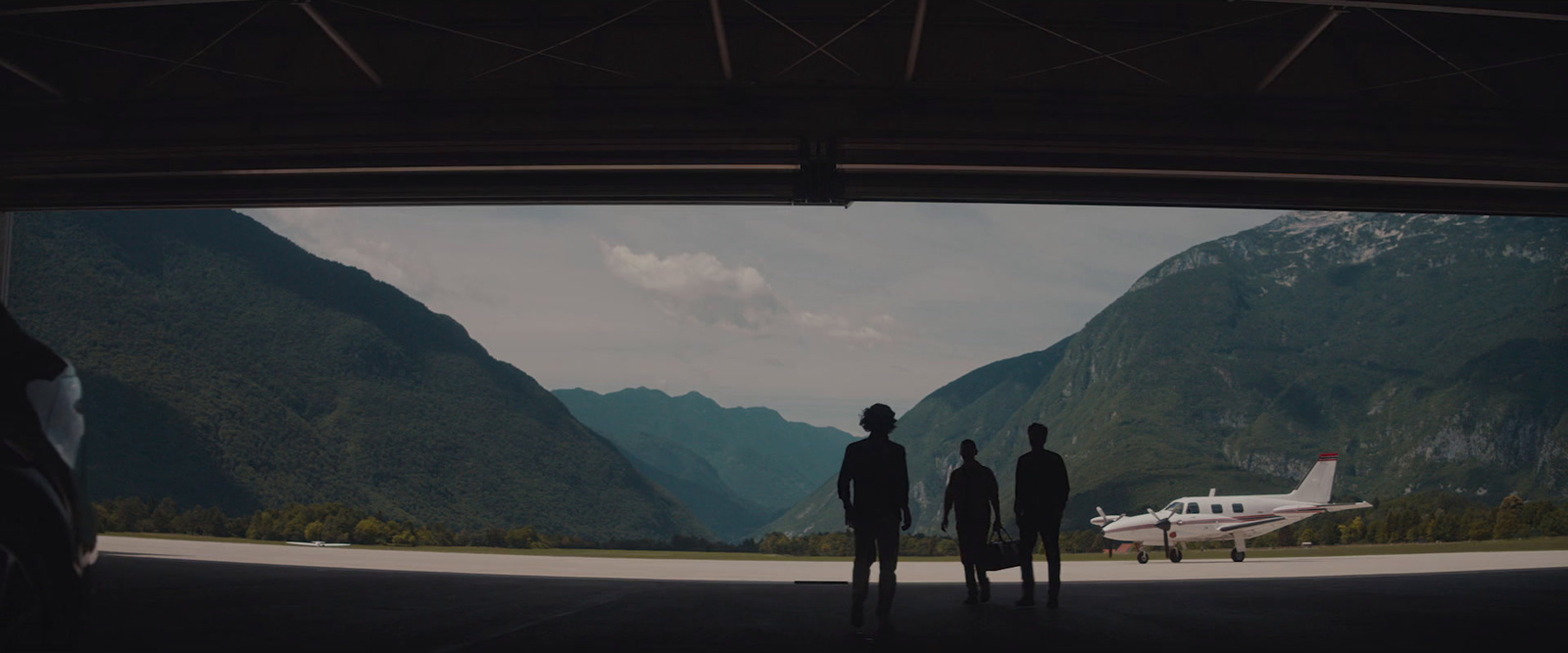 a group of people standing in front of a plane