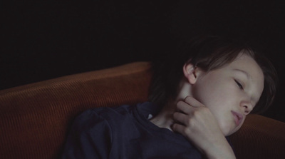 a young boy is sleeping in a chair