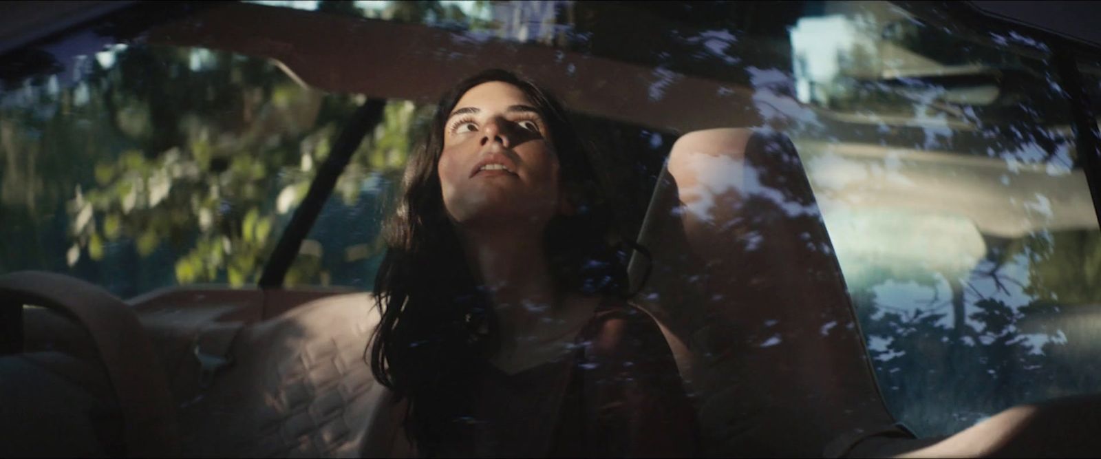 a woman sitting in the back seat of a car