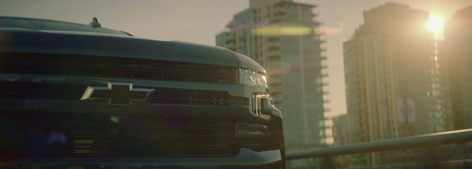 a truck parked in front of a tall building