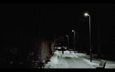 a bench sitting on the side of a snow covered road