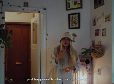 a woman with long blonde hair standing in a room