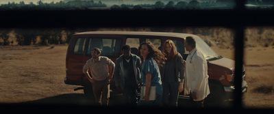 a group of people standing in front of a van