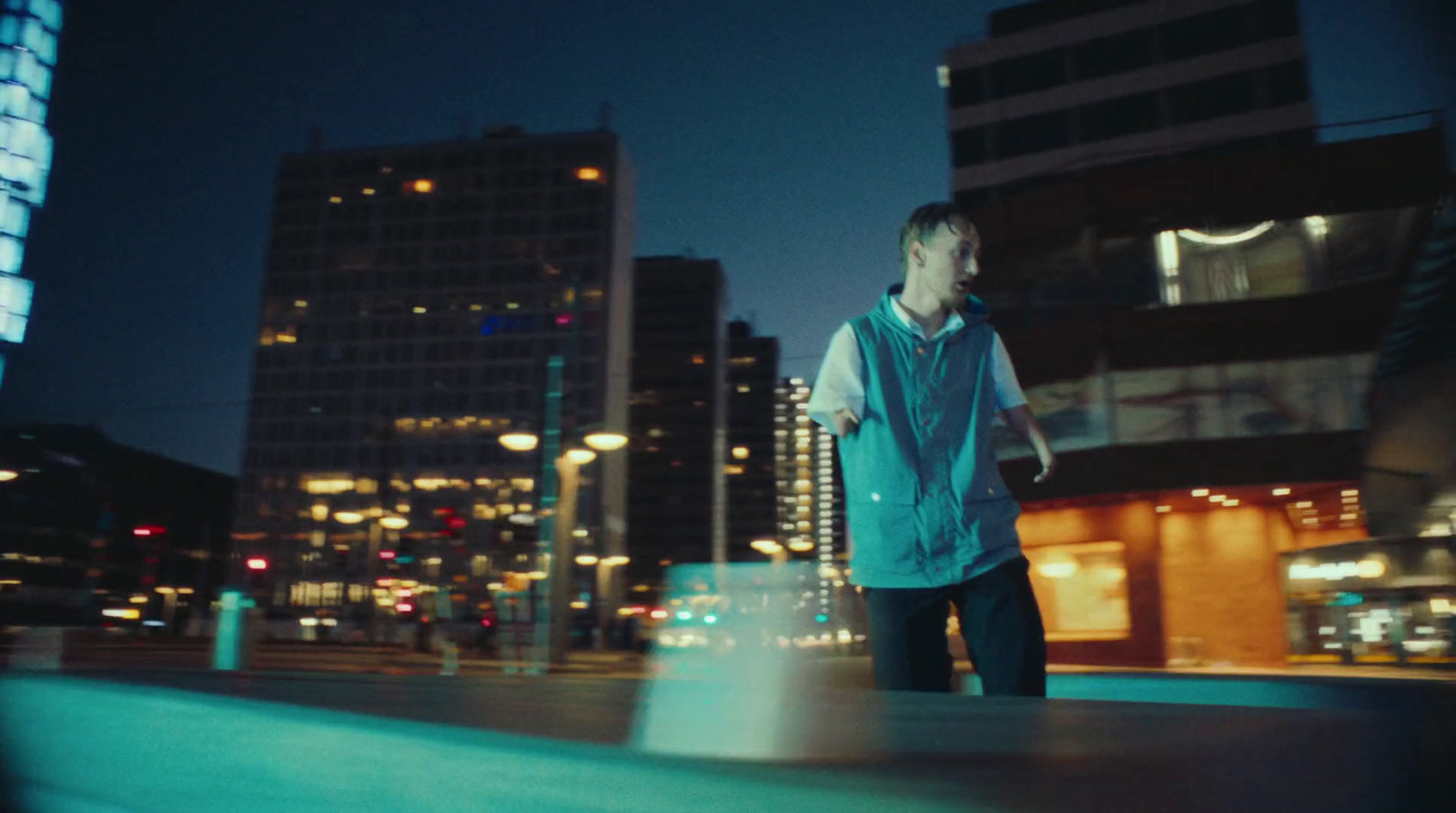 a man standing in the middle of a city at night