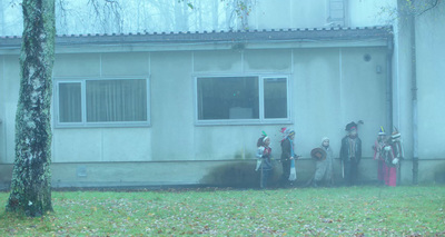 a group of people standing in front of a house