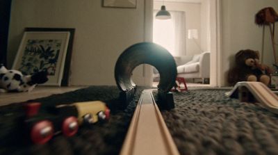 a toy train is on the floor of a bedroom