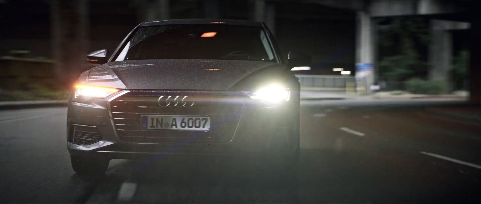 a car driving down a street at night