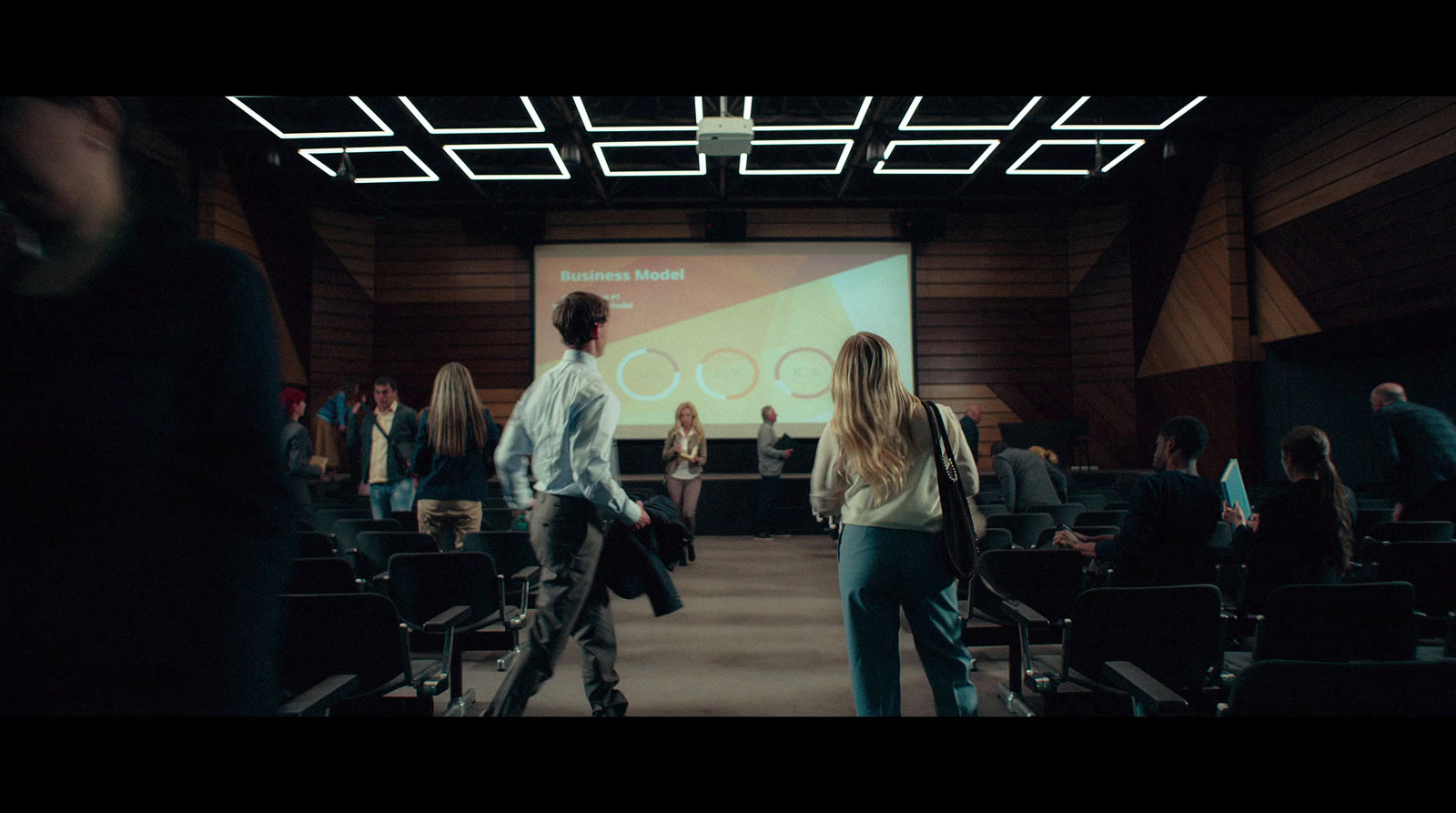 a group of people standing in front of a projector screen