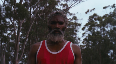 a man with a beard wearing a red shirt