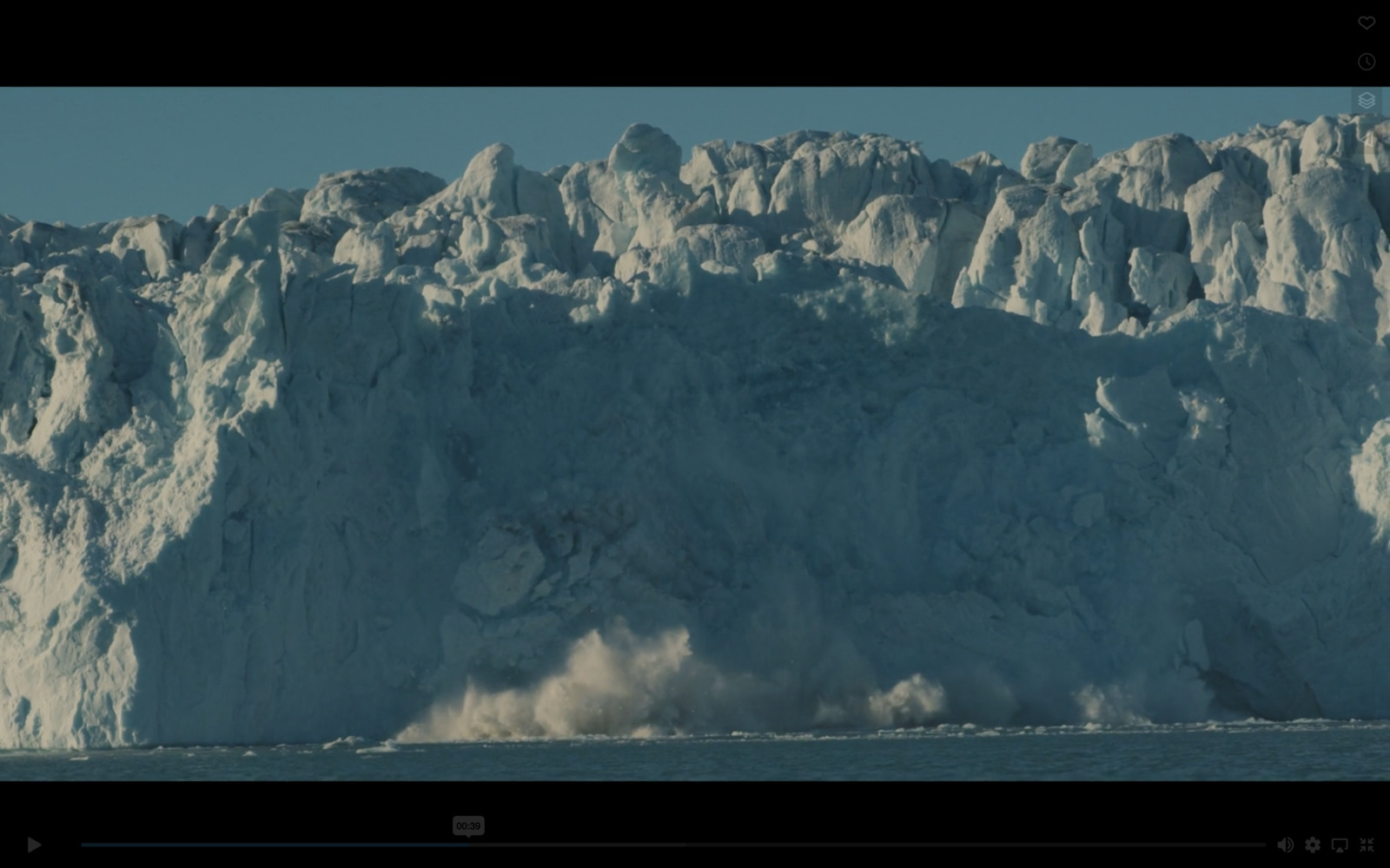 a large iceberg in the middle of the ocean