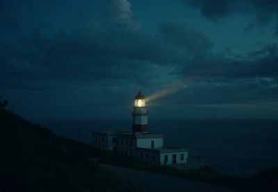 a lighthouse on top of a hill at night