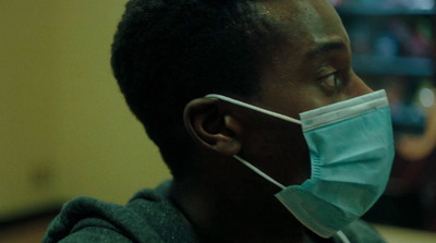 a man wearing a face mask in a room