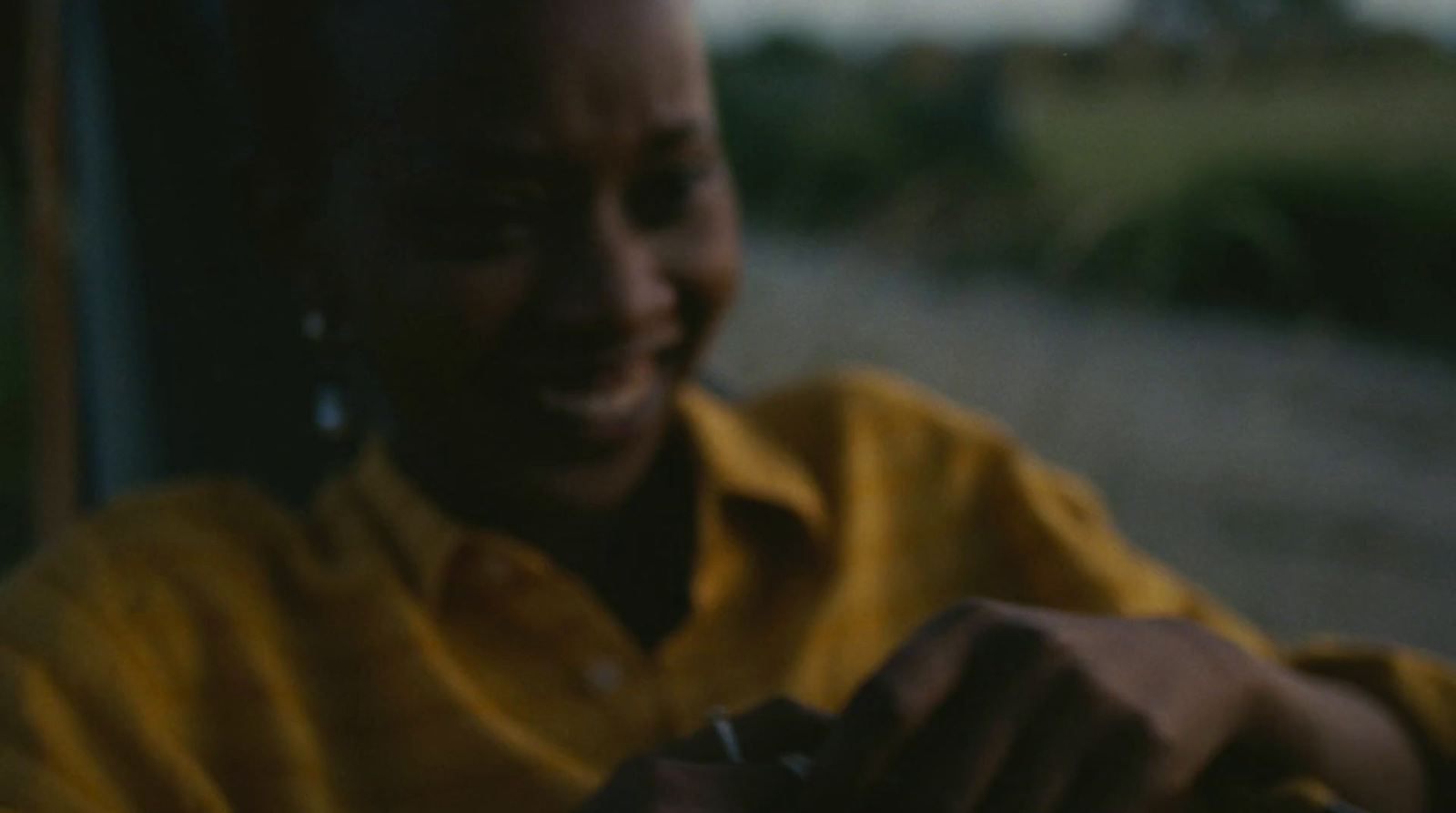 a man in a yellow shirt holding a cell phone