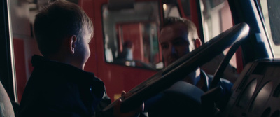 a man and a young boy sitting on a bus