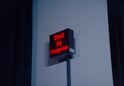 a red sign that says test in progress