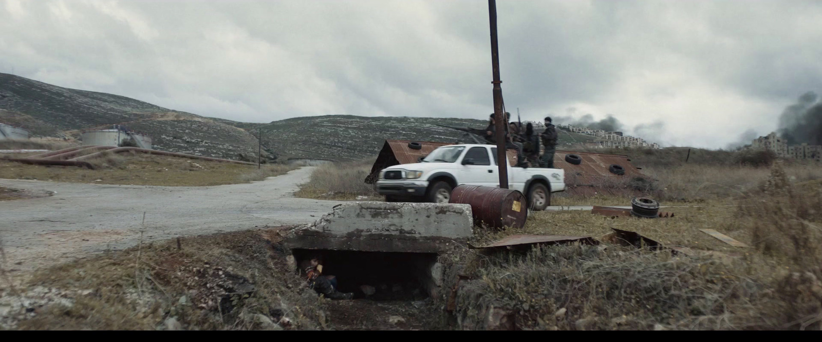 a white truck parked on a dirt road