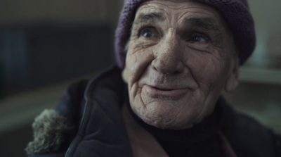 an old man wearing a purple hat and jacket