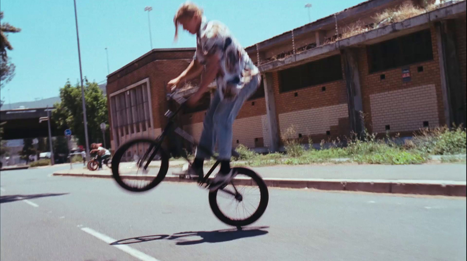 a man riding a bike down the middle of a street