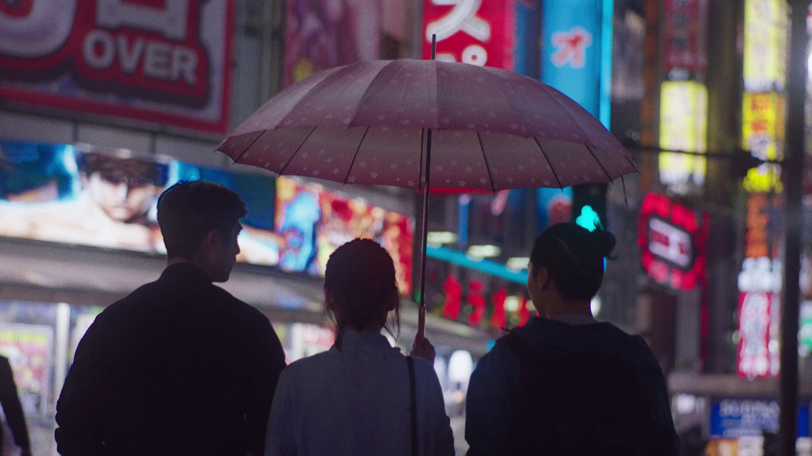 a group of people standing under an umbrella