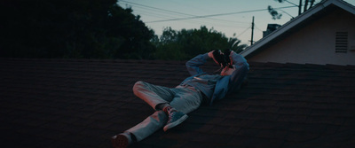 a man laying on the roof of a house