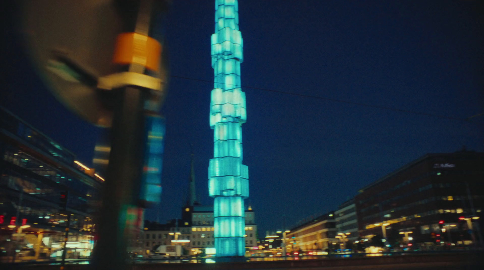 a tall building lit up at night in a city