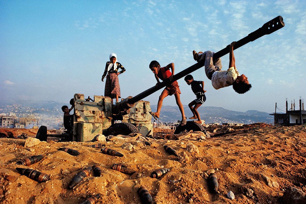 a group of people hanging upside down on a pole