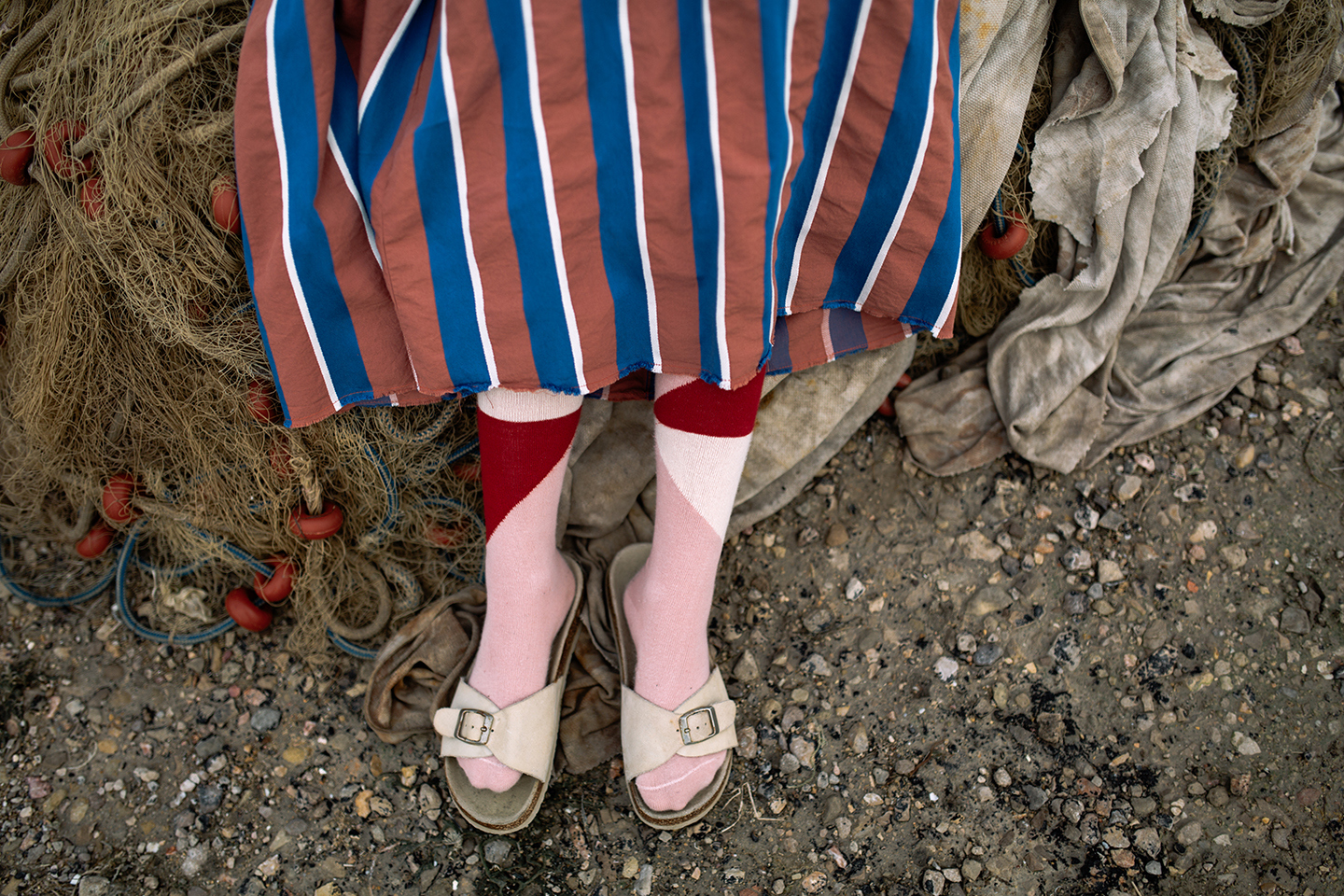 a close up of a person's legs wearing a dress and shoes