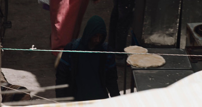 a woman standing in front of a stove top oven