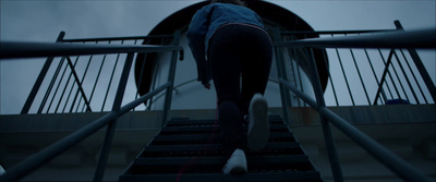 a woman walking up a flight of stairs