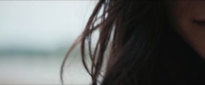 a close up of a woman's face with a blurry background