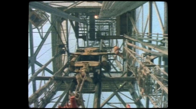 a group of people standing on top of a metal structure