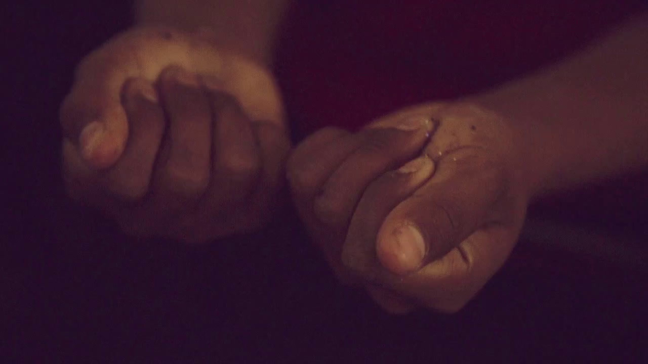 a close up of two hands holding each other