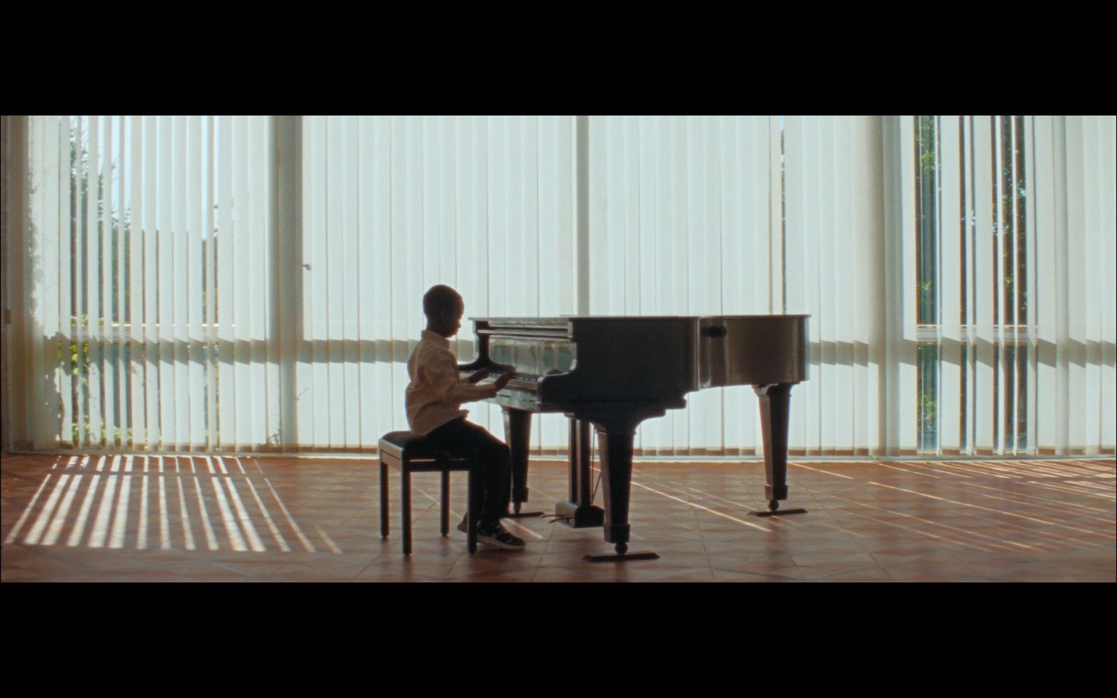 a person sitting at a piano in a room