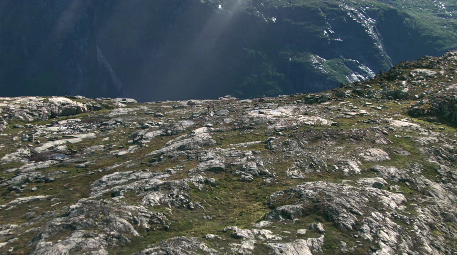 a person standing on top of a rocky mountain