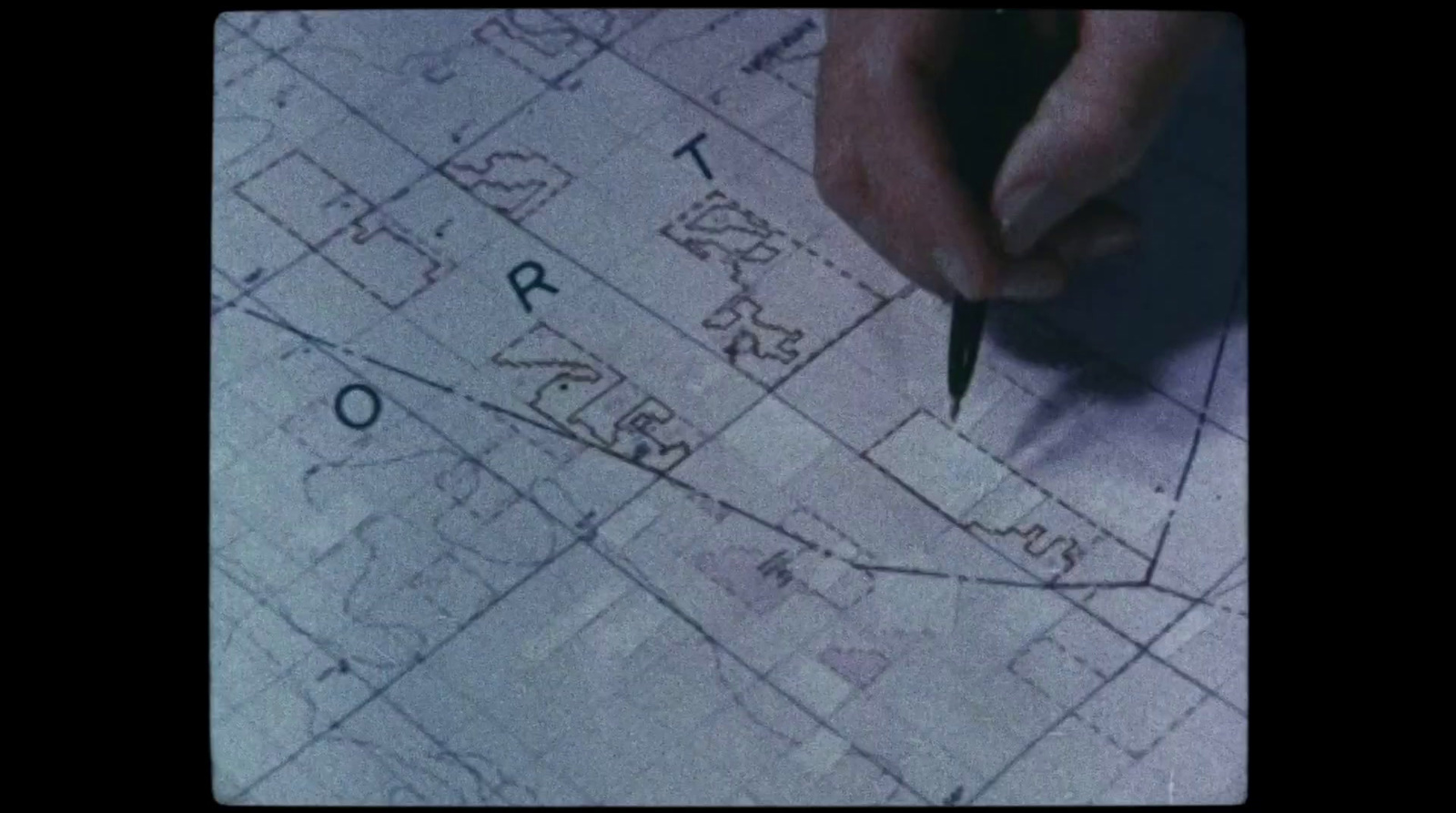 a person writing on a map with a pencil