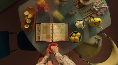 a person sitting at a table with an open book