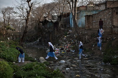 a group of people standing next to a river