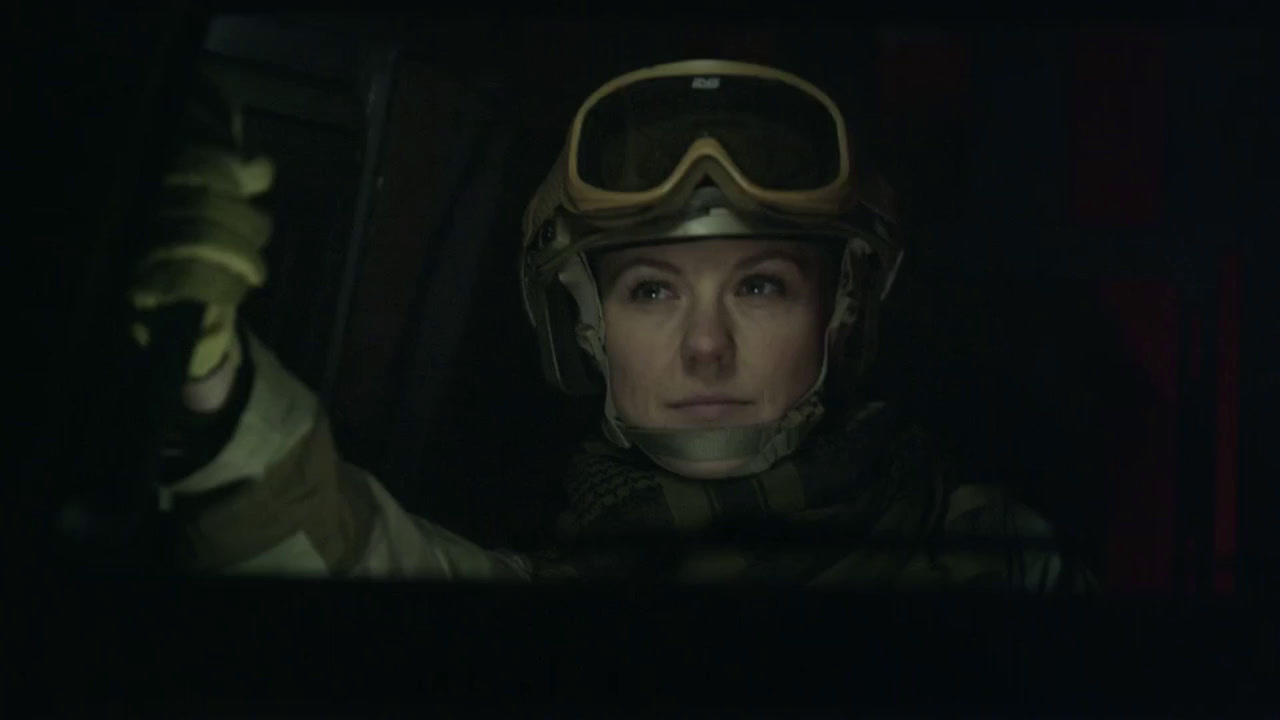 a woman wearing a helmet and goggles in the dark