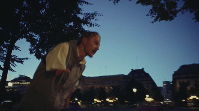 a man riding a skateboard down a sidewalk