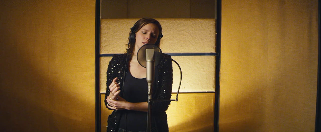 a woman standing in front of a microphone