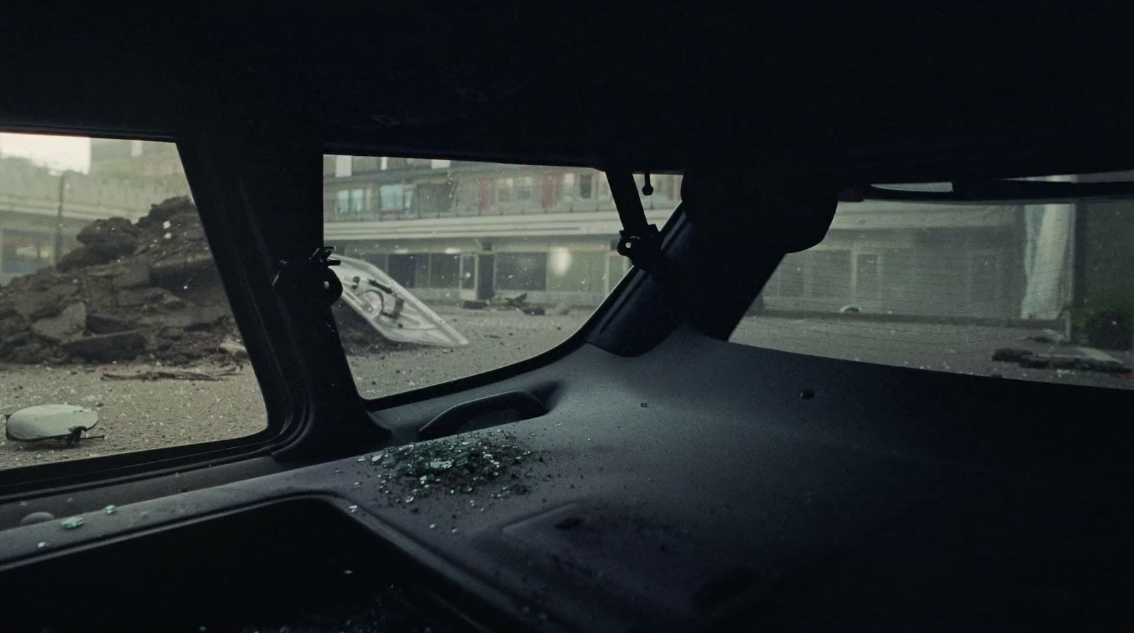 a view from inside a vehicle of a destroyed building