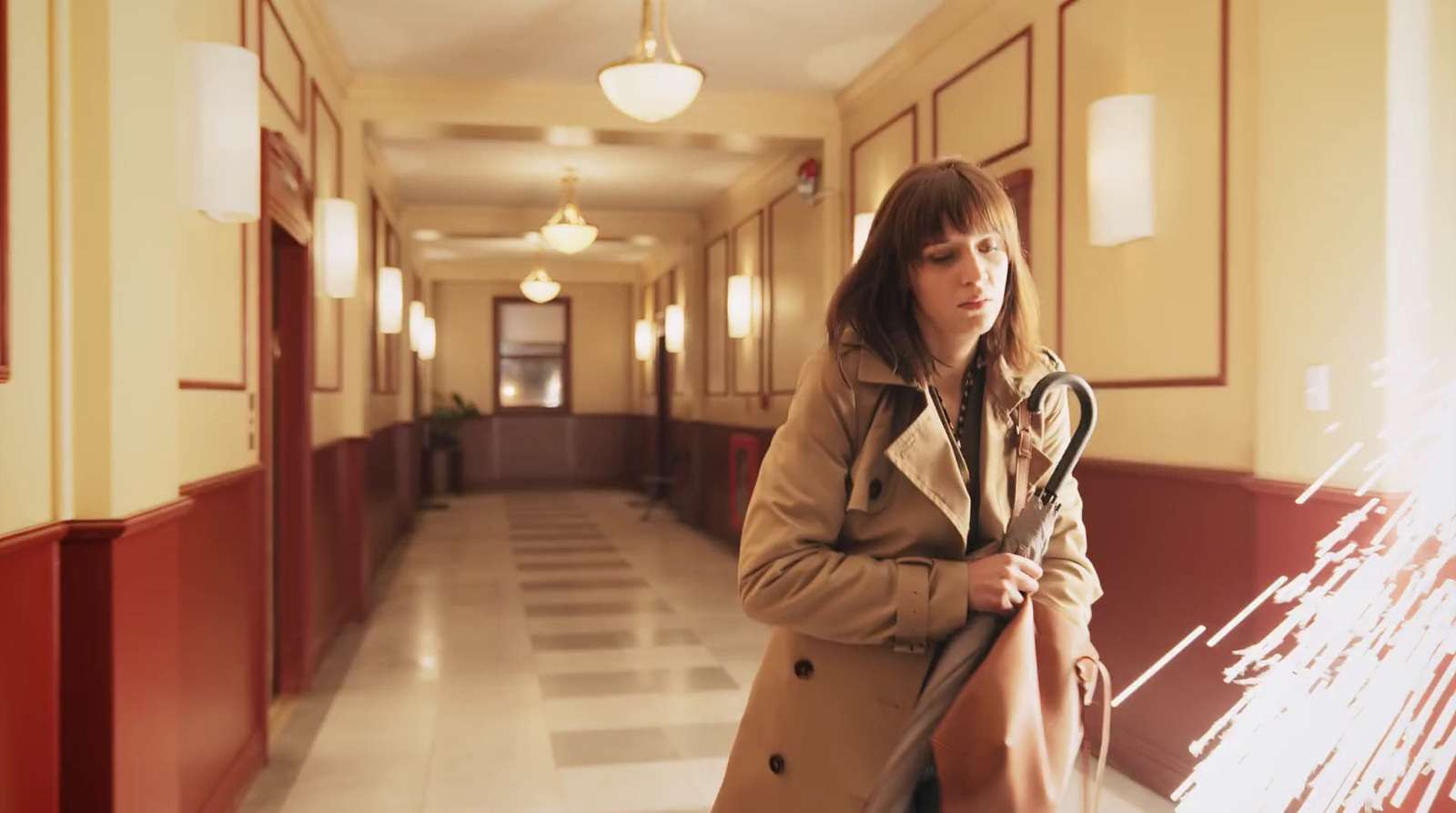 a woman standing in a hallway with a cane