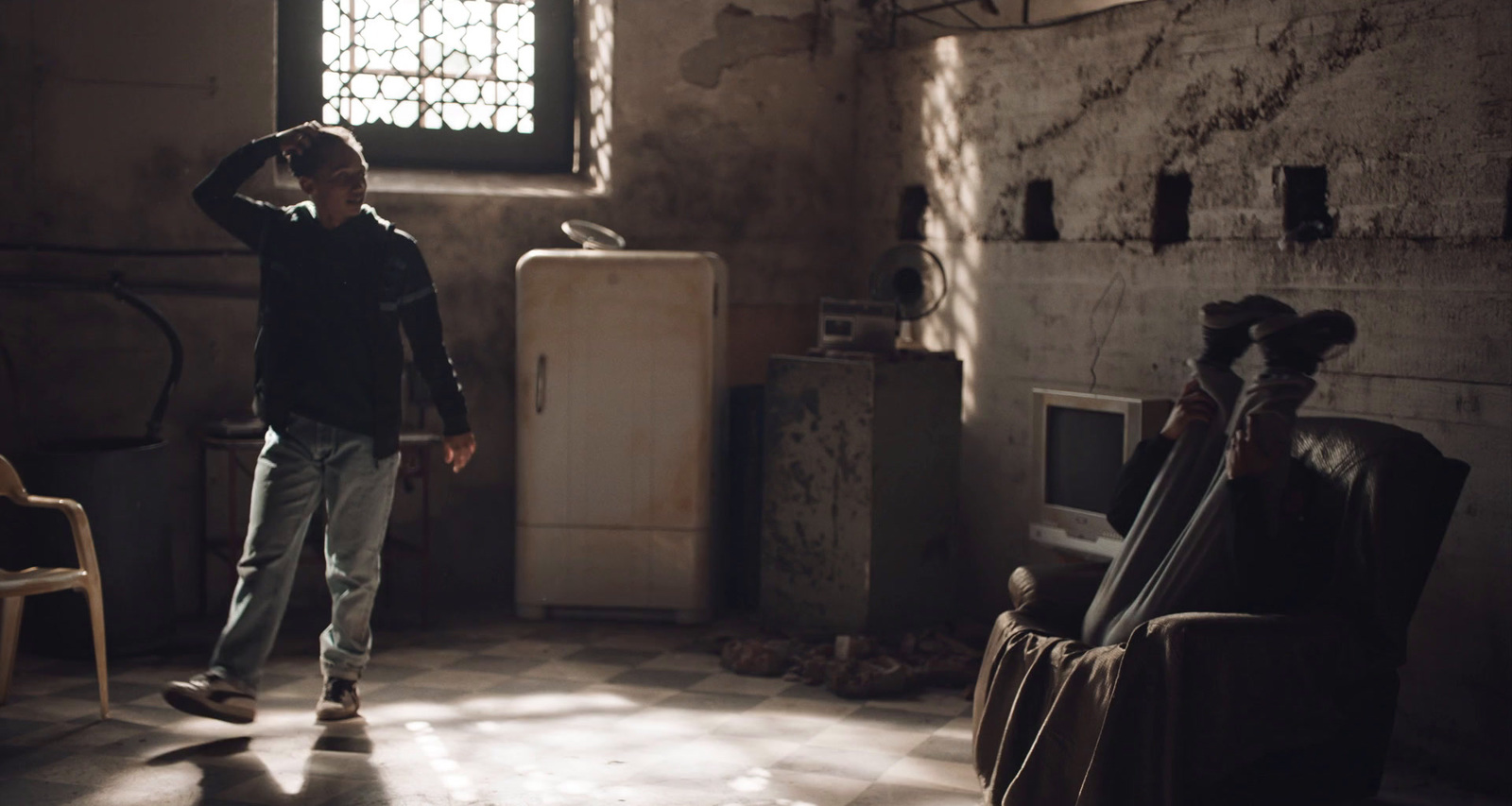 a boy standing in a room with a guitar