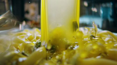 a close up of a yellow vase on a table