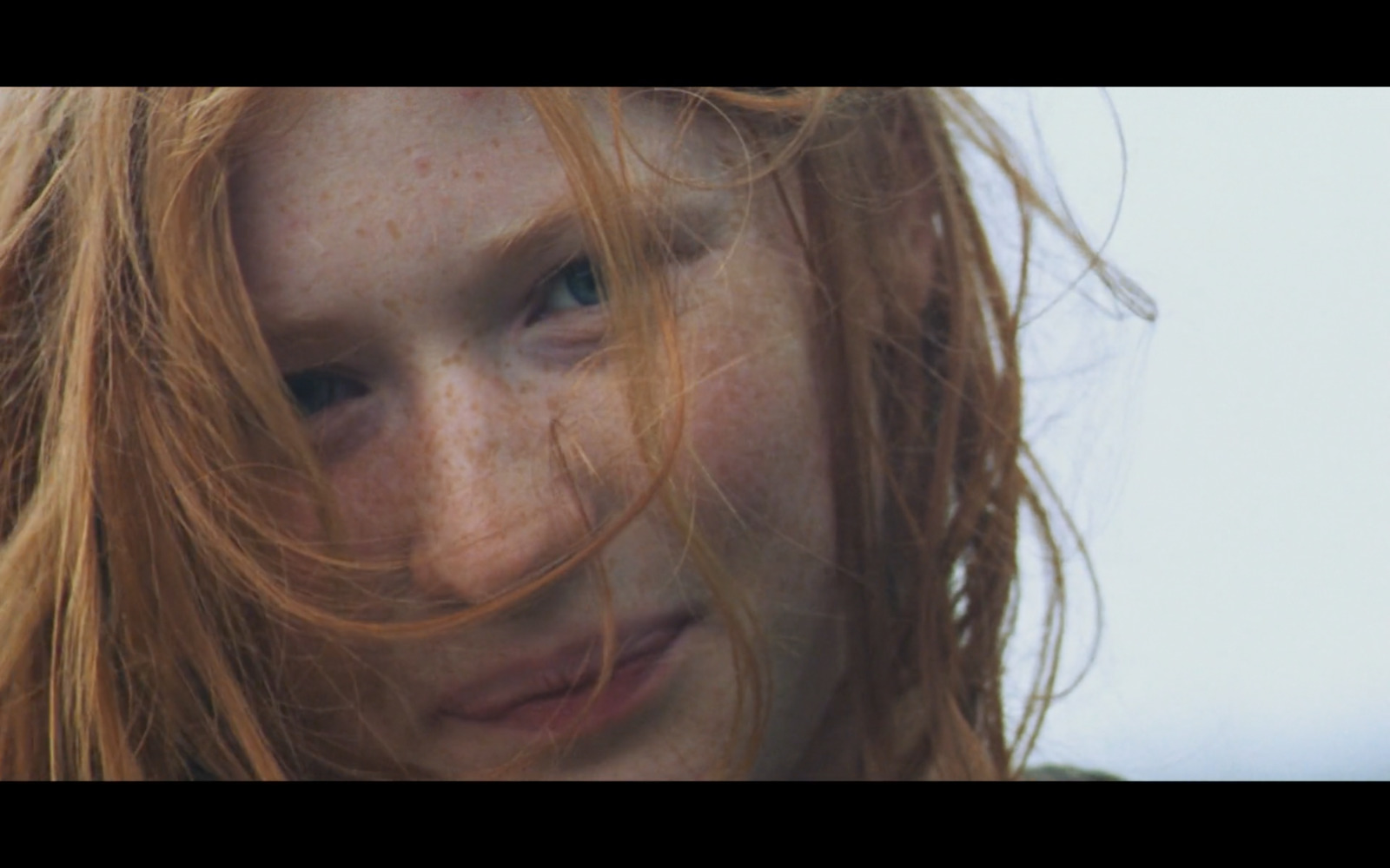 a close up of a woman with freckled hair