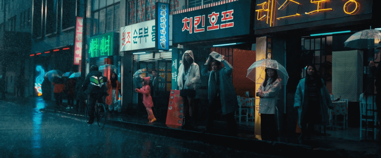 a group of people standing outside of a store