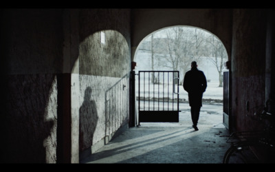 a person walking down a hallway with a gate