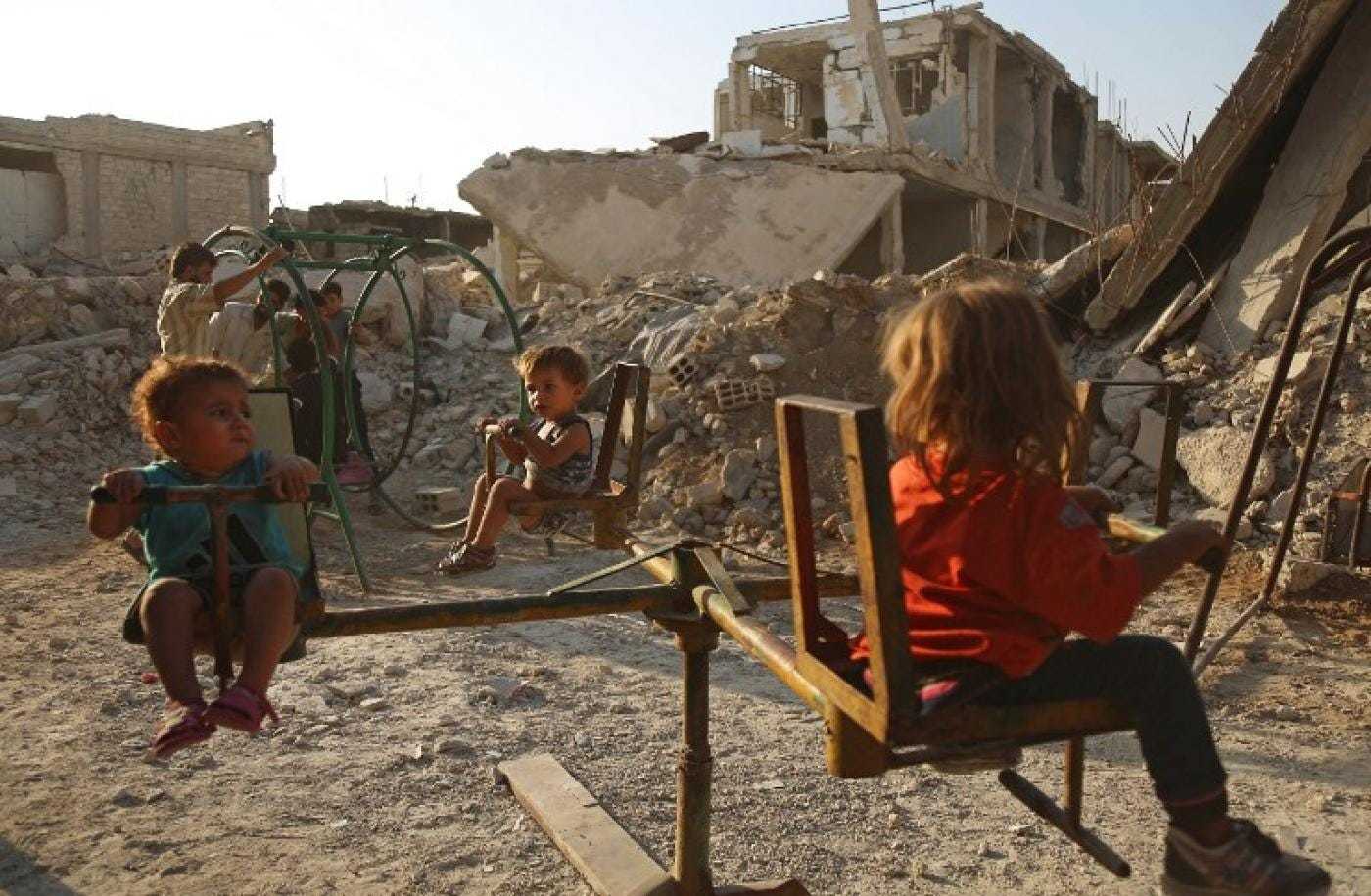 a group of young children sitting on top of a wooden chair