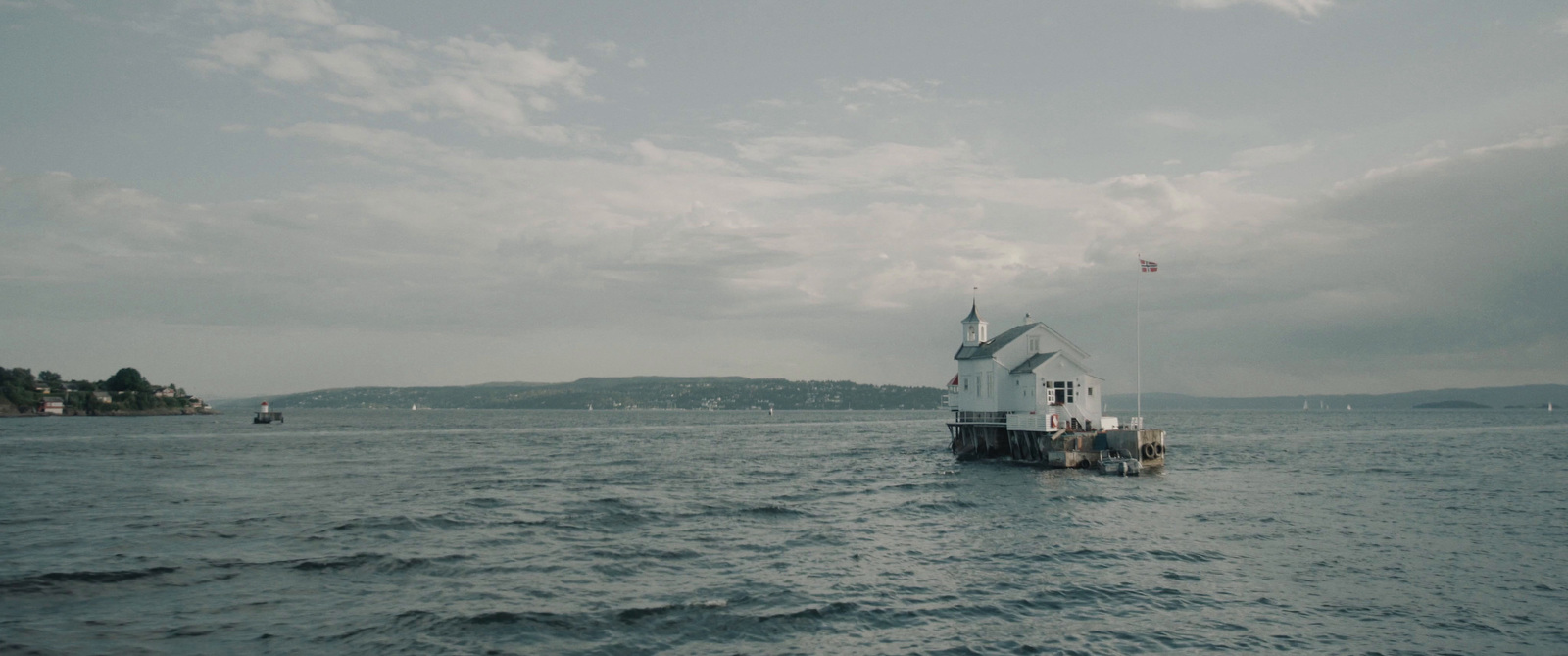 a lighthouse in the middle of a body of water