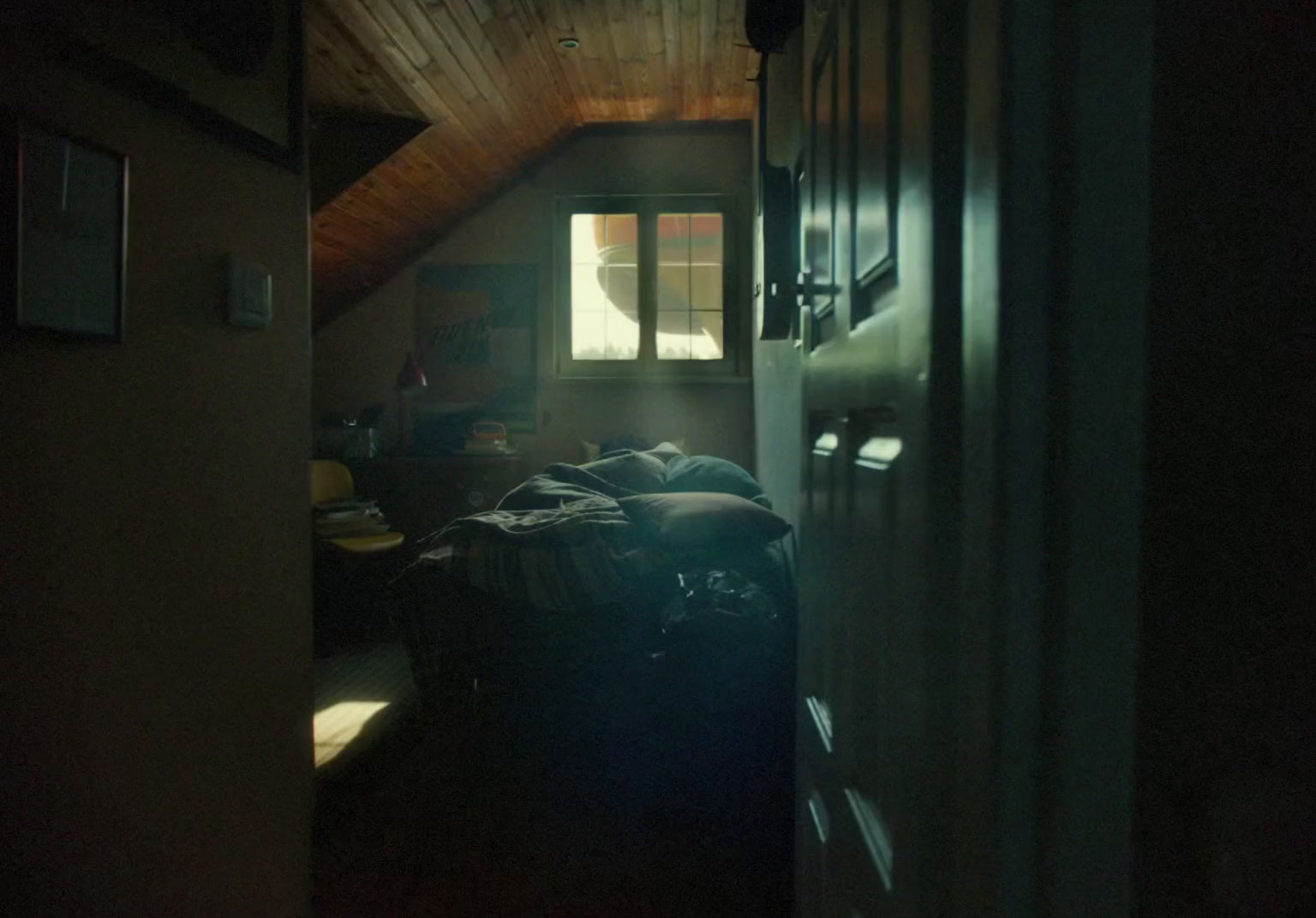 a dimly lit room with luggage on the floor